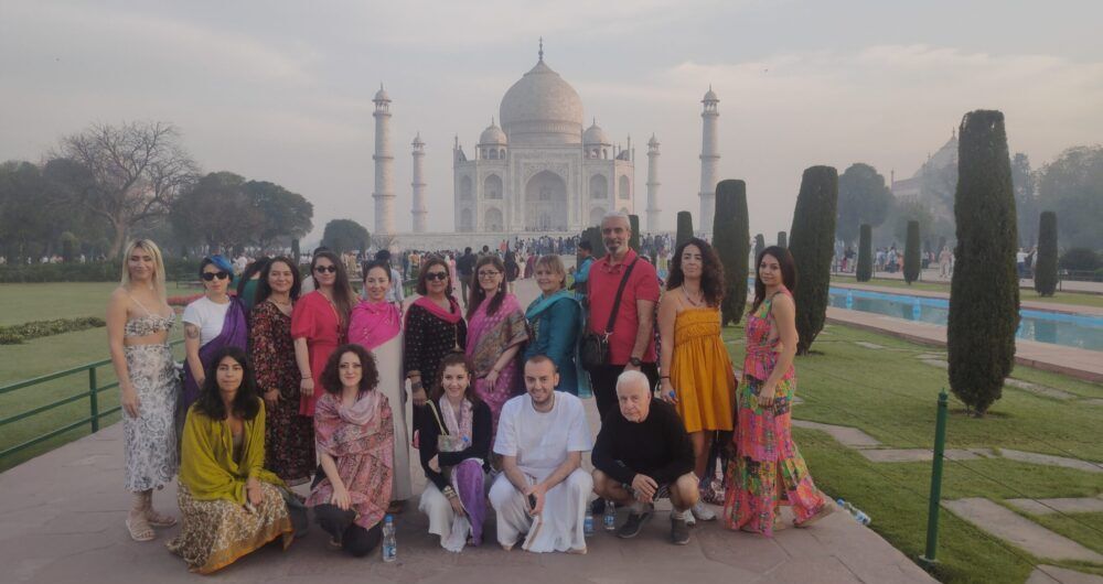 Foreigner tourist posing at Taj Mahal during guided tour in Agra India