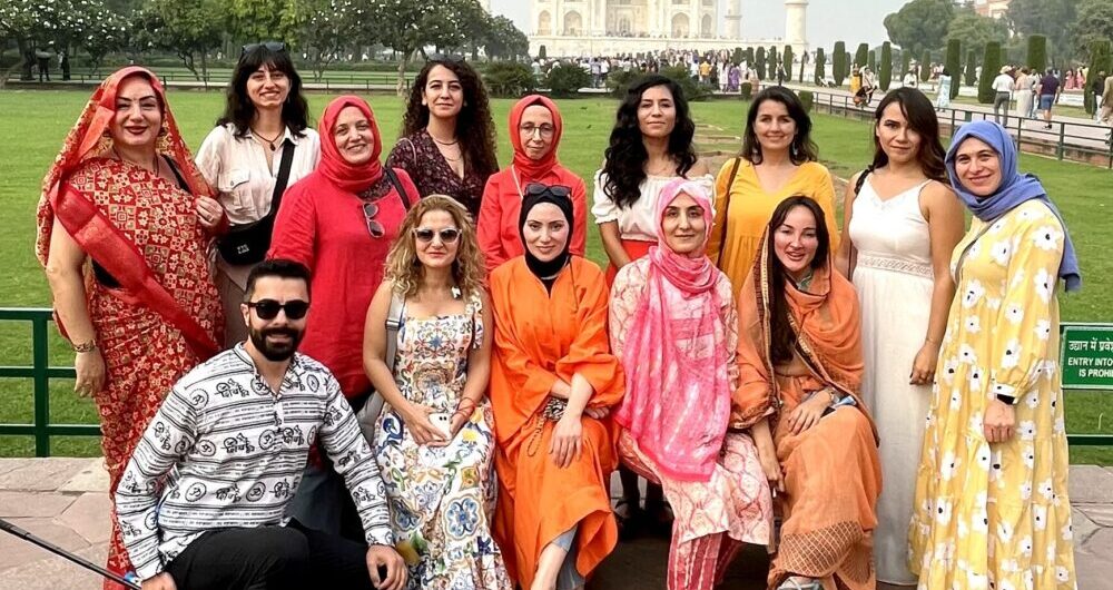 Tourist group taking photos in front of Taj Mahal during Golden Triangle Tour 4 Days